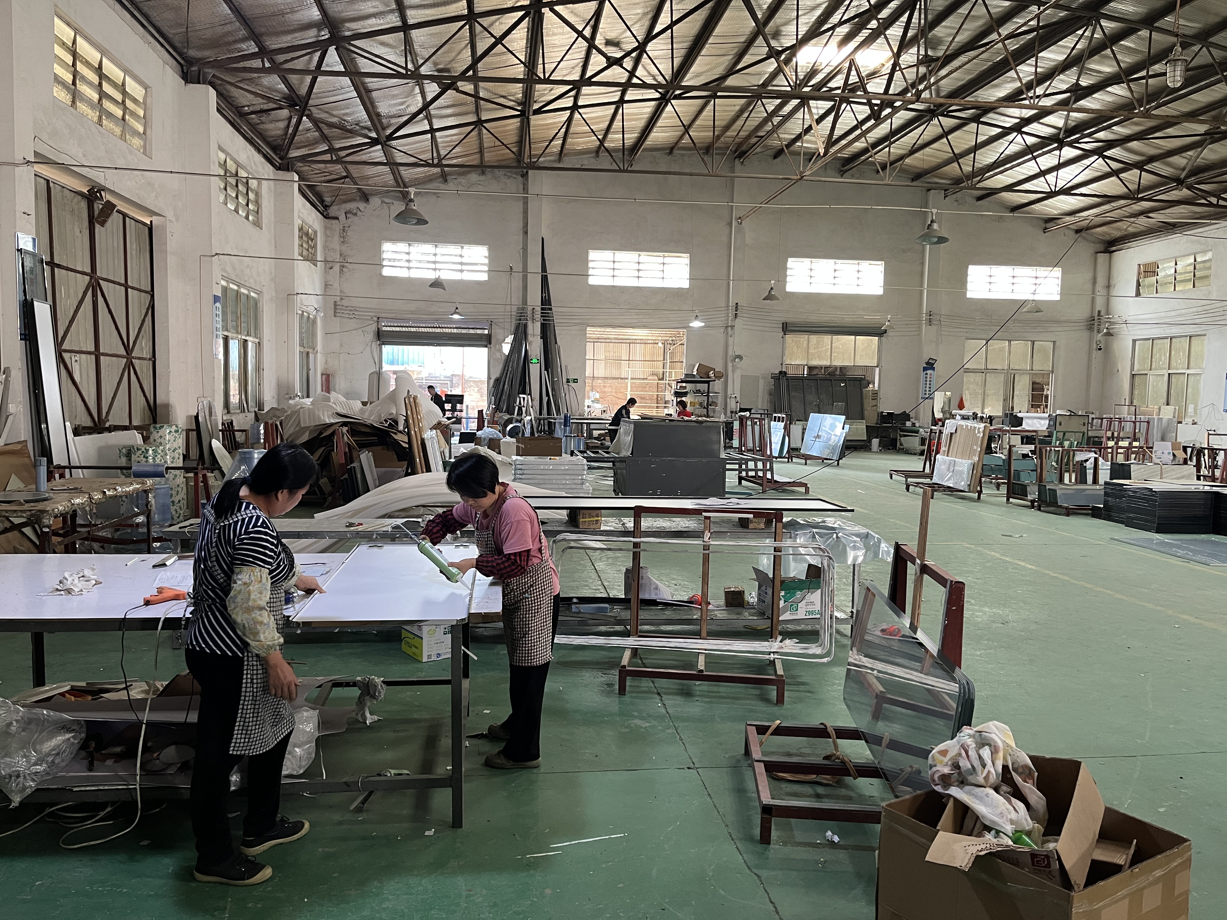 LED mirror production workshop with assembly tables