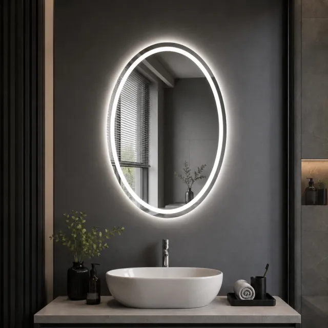 Oval illuminated LED bathroom mirror above vanity